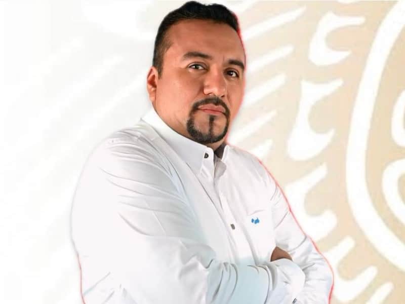 David Castillejos Cruz, regidor de Educación en Oaxaca. David Castillejos Cruz posando con un fondo del Gobierno de México.