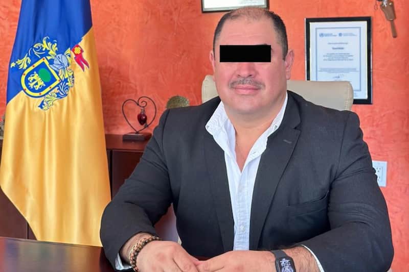 José Ascención Murguía Santiago, alcalde de Teuchitlán. Murguía Santiago con cintilla negra posando en su oficina.